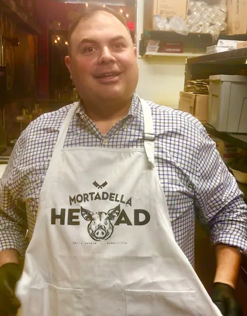 Sebby wearing Mortadella Head Apron