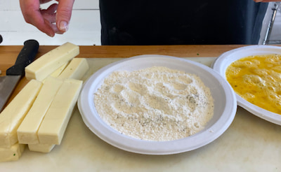 Cheese sticks frying in hot oil