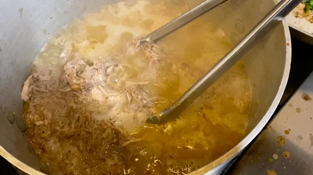 Pulled pork served on sandwich bun with sauce