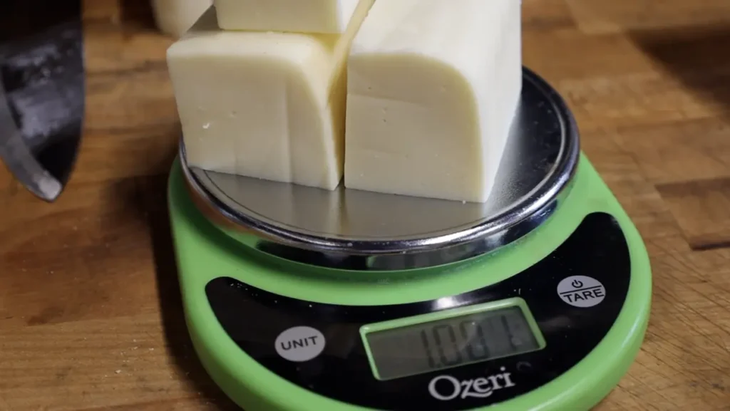 Measuring cups filled with shredded mozzarella