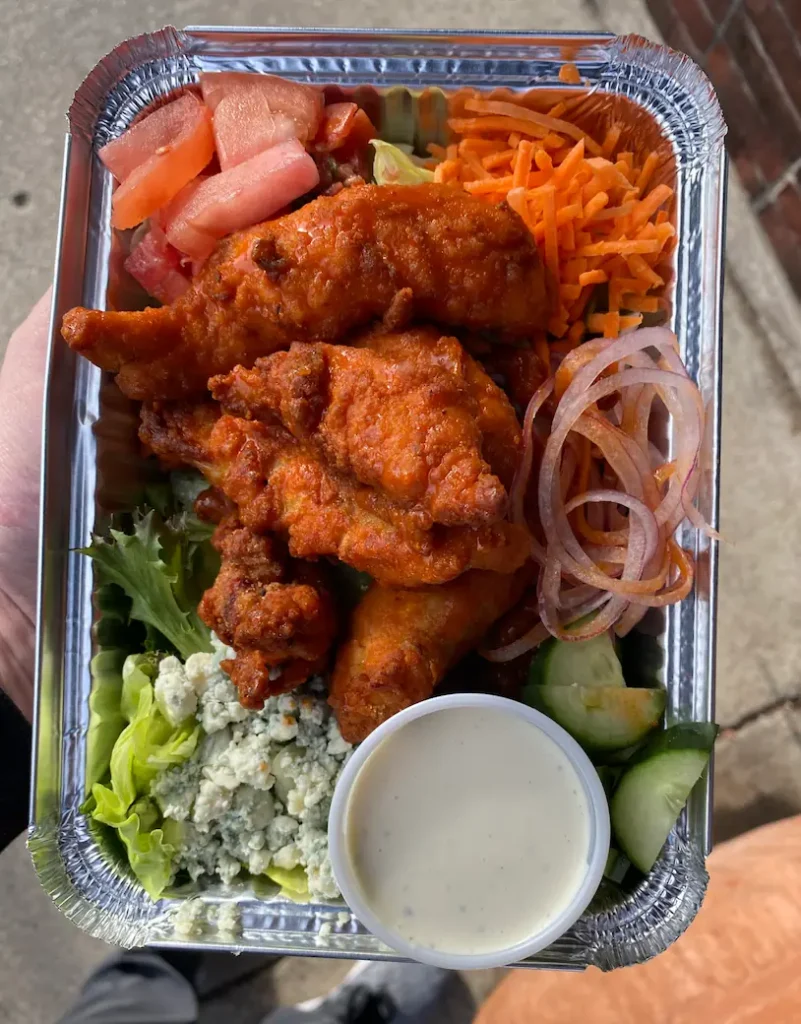 Chicken wings served on a platter with dipping sauces
