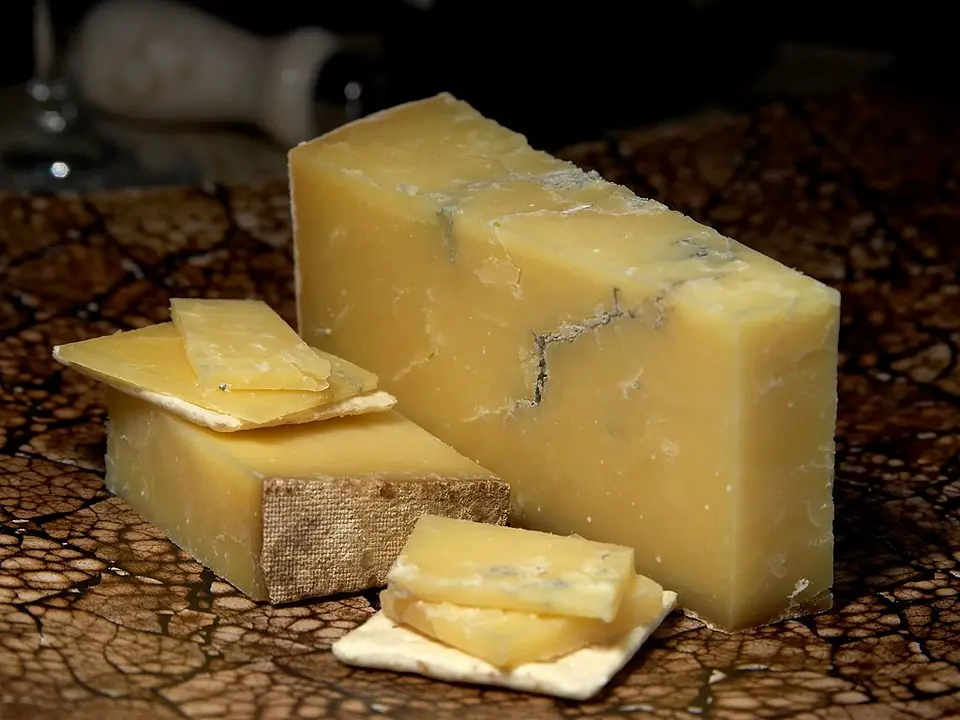 cheese sauce without flour-a big piece of cheddar ready to be grated for this cheese sauce recipe