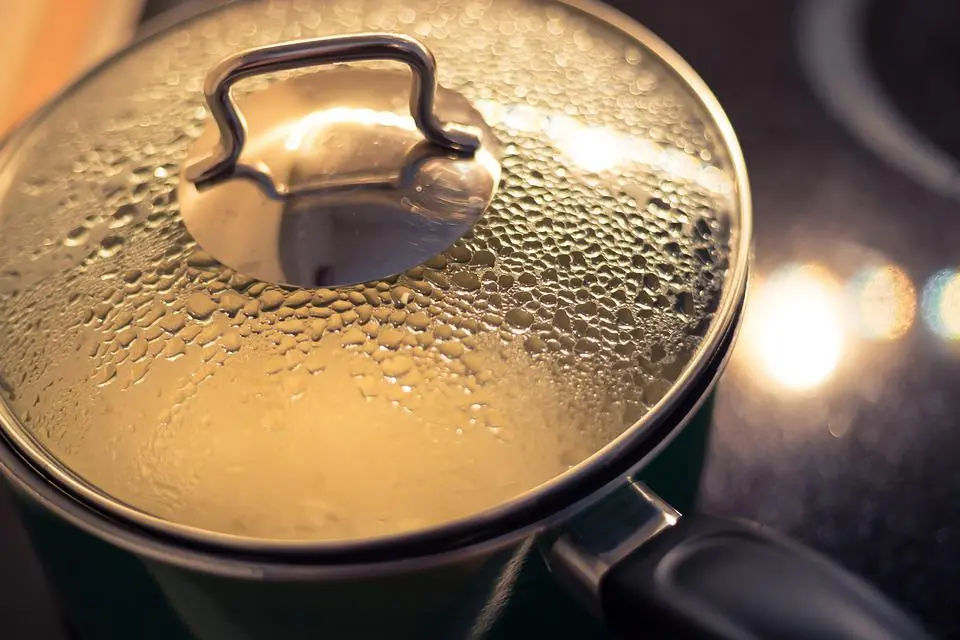 a pot full of boiling water, covered with a lid