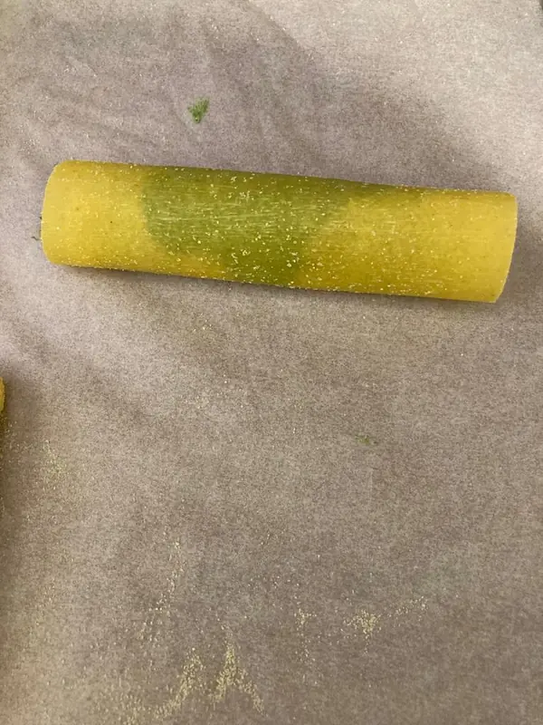 a rolled up lasagna sheet full of ricotta mix
