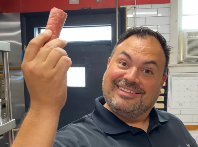 Sebby holding a knockwurst