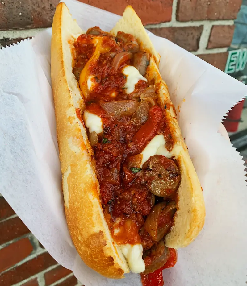a sandwich full with baked italian sausage