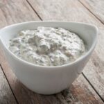 a small bowl full of garlic pizza sauce