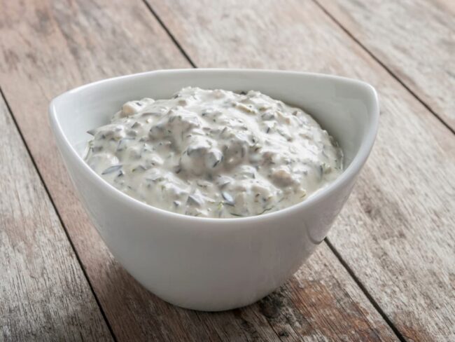a small bowl full of garlic pizza sauce