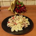 a plate of spicy tuna pasta next to a bunch of Calabrian chili peppers