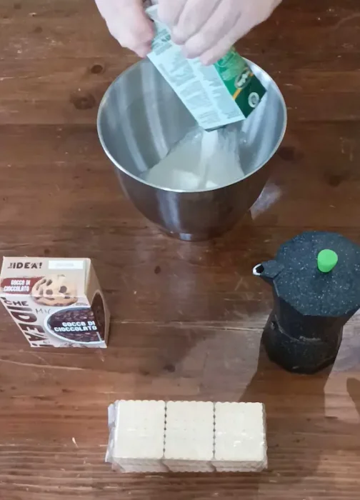 adding whipping cream to a large bowl