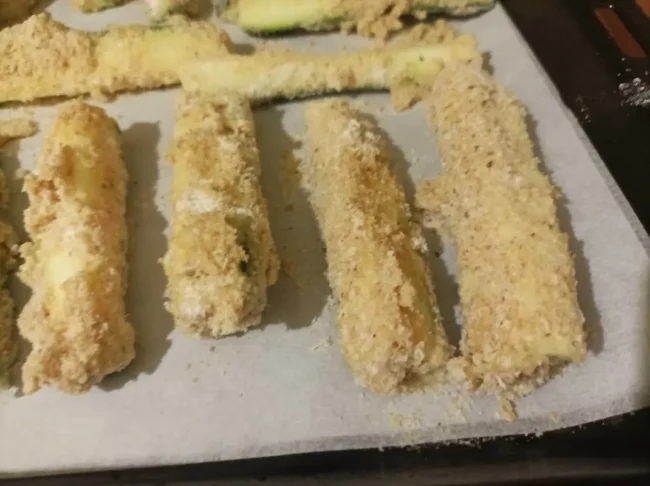 zucchini fries on a baking dish