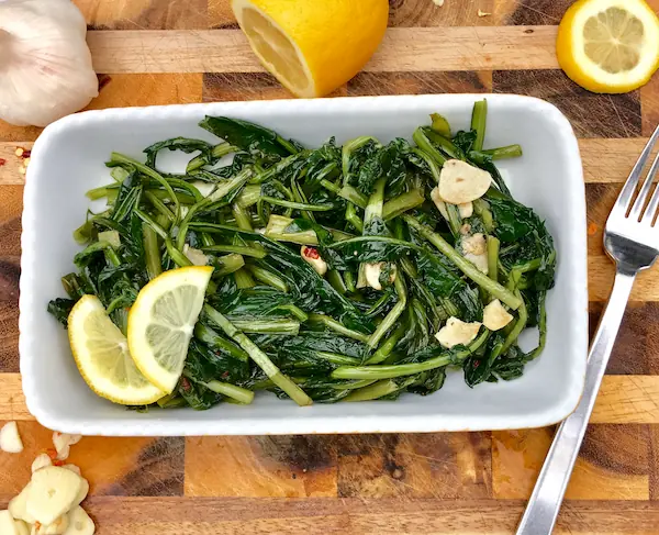 Finished dish of dandelion greens cooked with olive oil, garlic and lemon