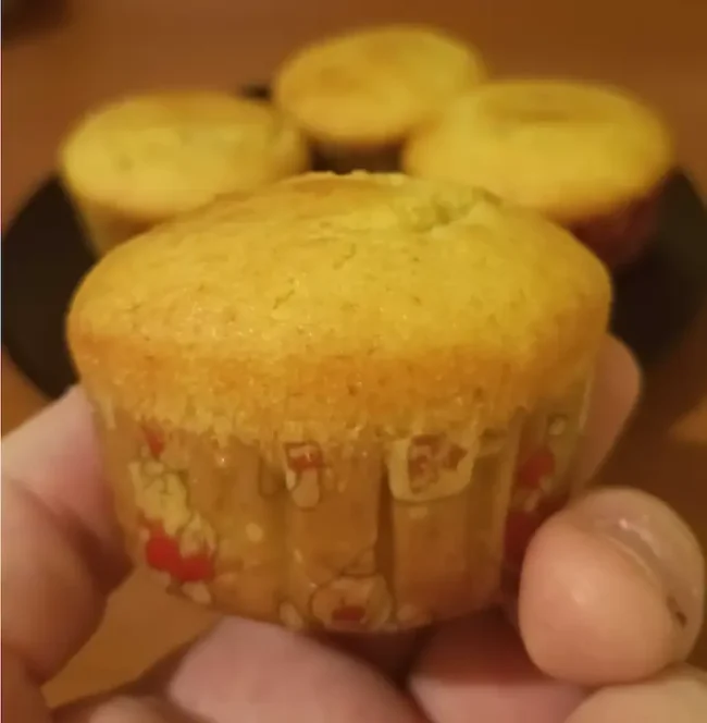italian christmas desserts-a hand holding a light greek yogurt muffin made for Christmas