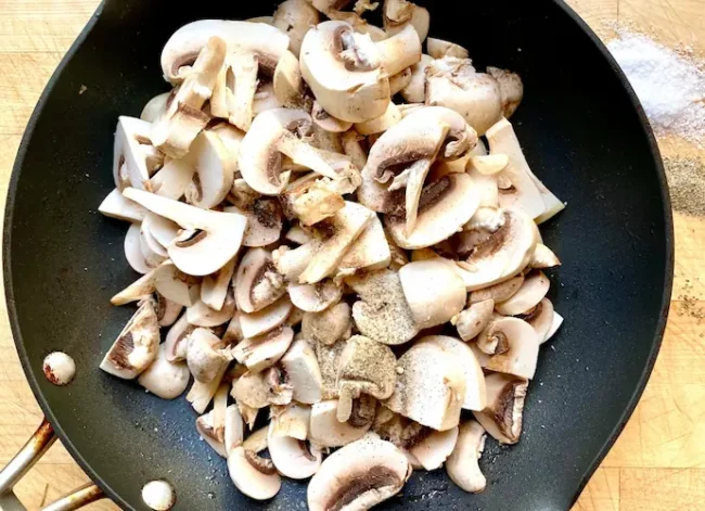 mushroom pizza-sauteeing mushrooms in a large pan