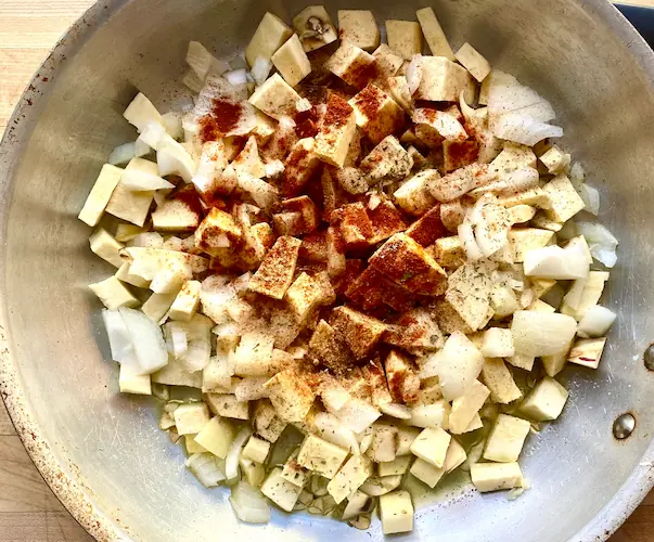 sweet potato cubes with spices in a pan