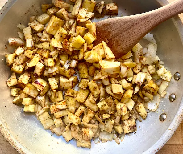 sweet potatoes sauteeing in olive oil on medium heat