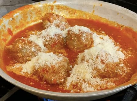 Cooked meatballs coated in rich red sauce