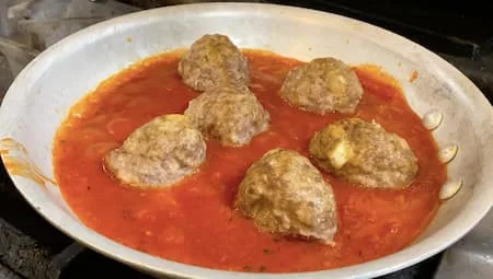 Close-up of meatballs cooking on the stove