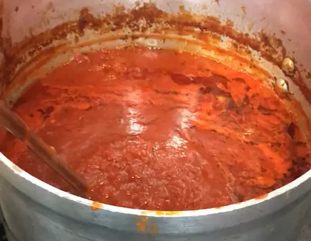 Cooked meatballs fully coated in tomato sauce