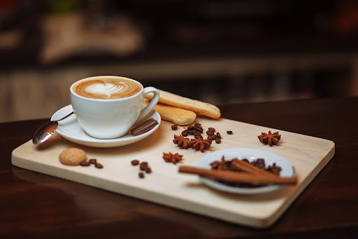 a cappuccino made with blonde espresso on a wooden tray with decorations
