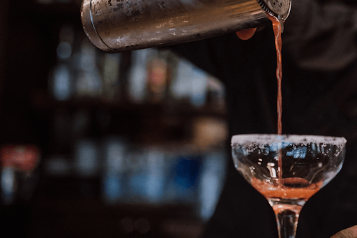 pouring vodka for Russian Kiss Cocktail