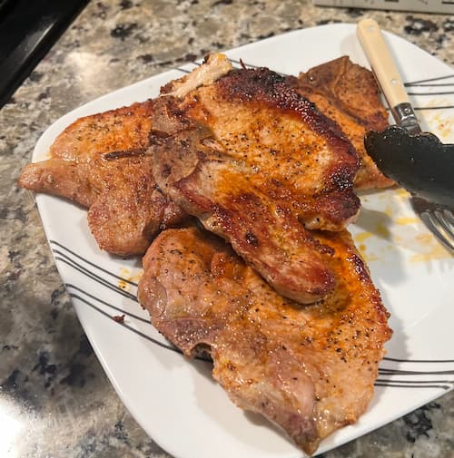 Finished pork chops served with simple side dish