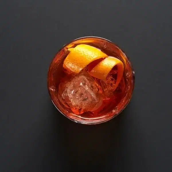 white negroni with mezcal - orange twist