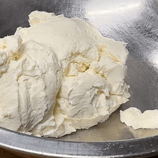Close-up of creamy ricotta texture in bowl