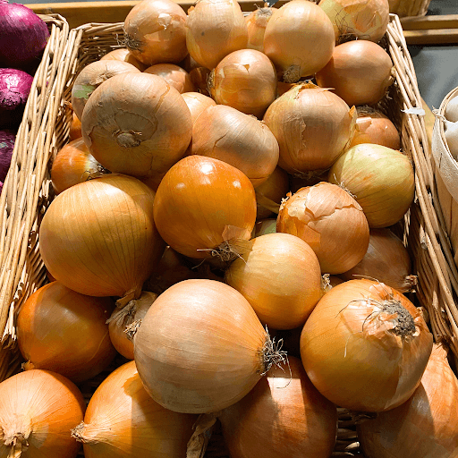Close up of onions in a storage container