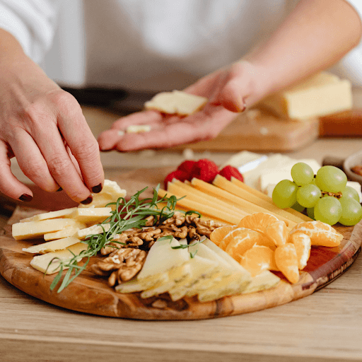 Assorted cheeses and salami on wooden board