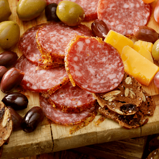 Close up of sliced cured meats on a board