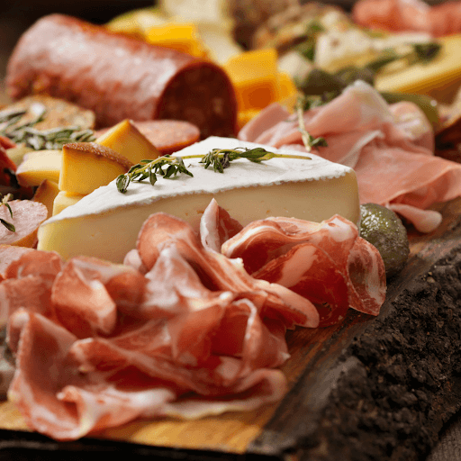 Charcuterie board with meats, cheese, and crackers