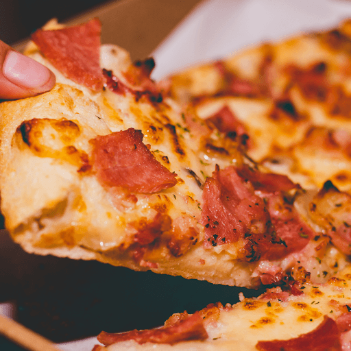 Close-up pizza slice showing browned cheese and toppings