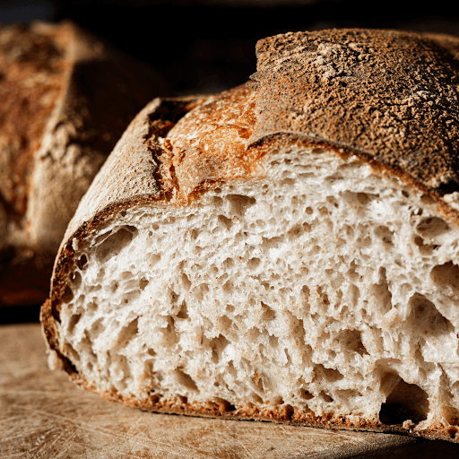 Crusty sourdough loaf showing soft interior crumb