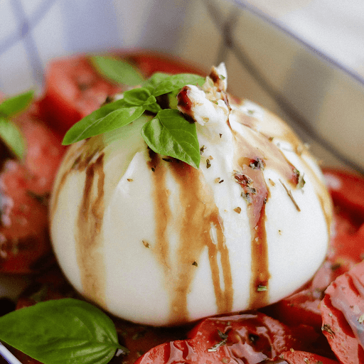 Fresh burrata topped with basil and balsamic glaze