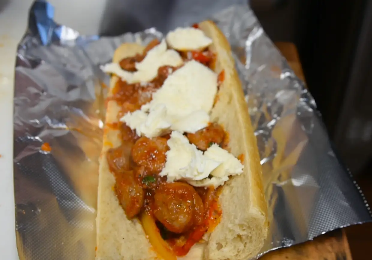 Filling piled high inside a sausage pepper and onion sub