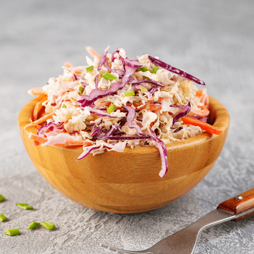 Close up of creamy coleslaw texture in a serving bowl